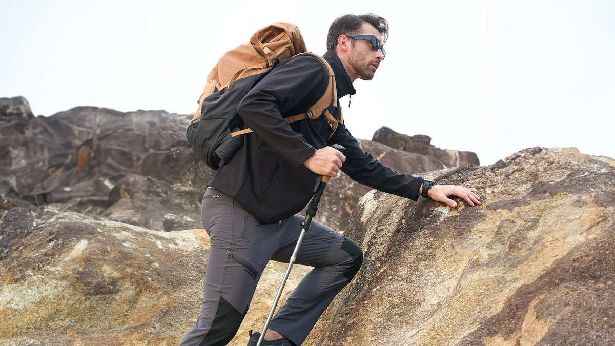 Man hiking in a black MAGCOMSEN winter softshell jacket